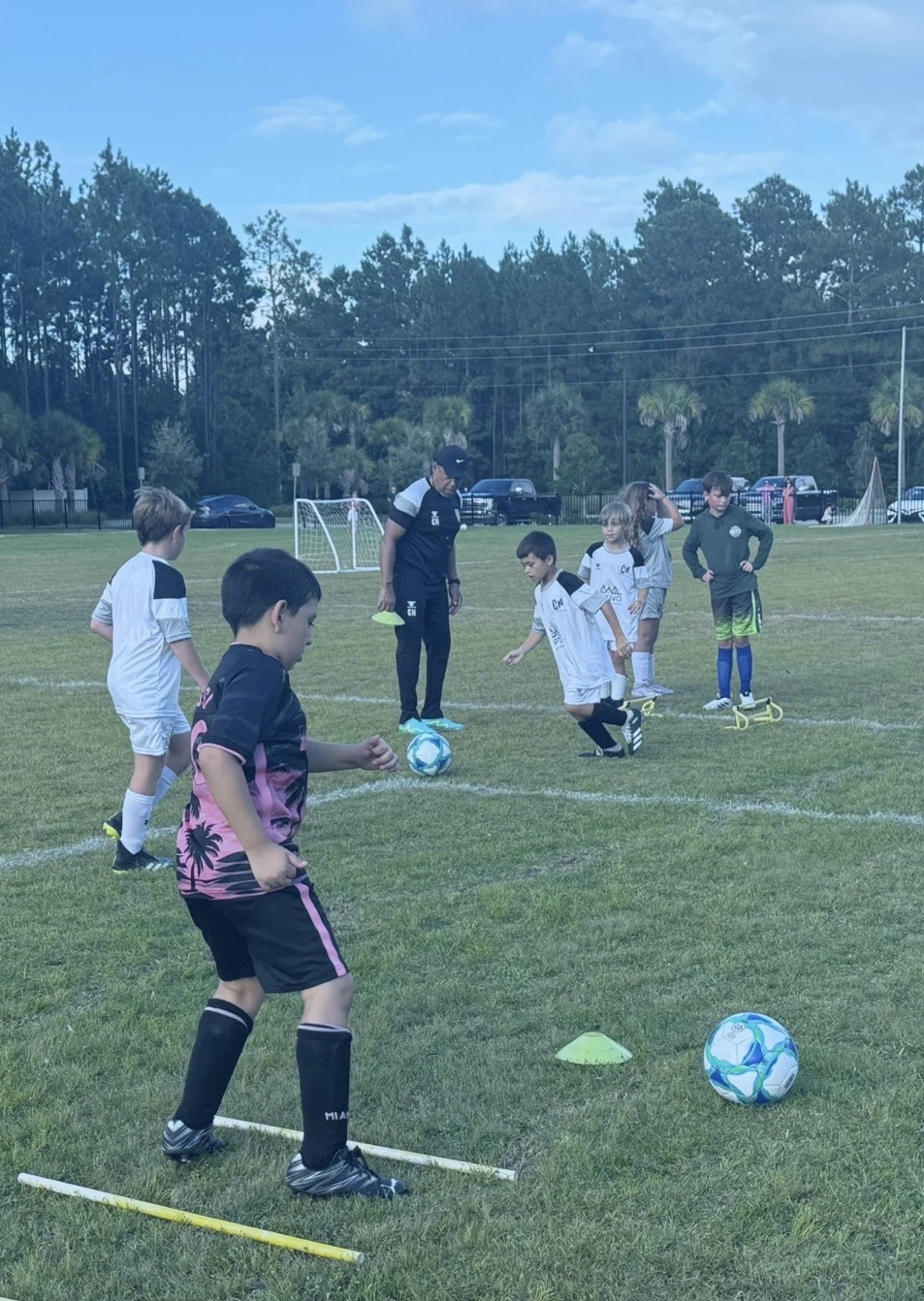 Young players practice ball skills with a CH4 coach
