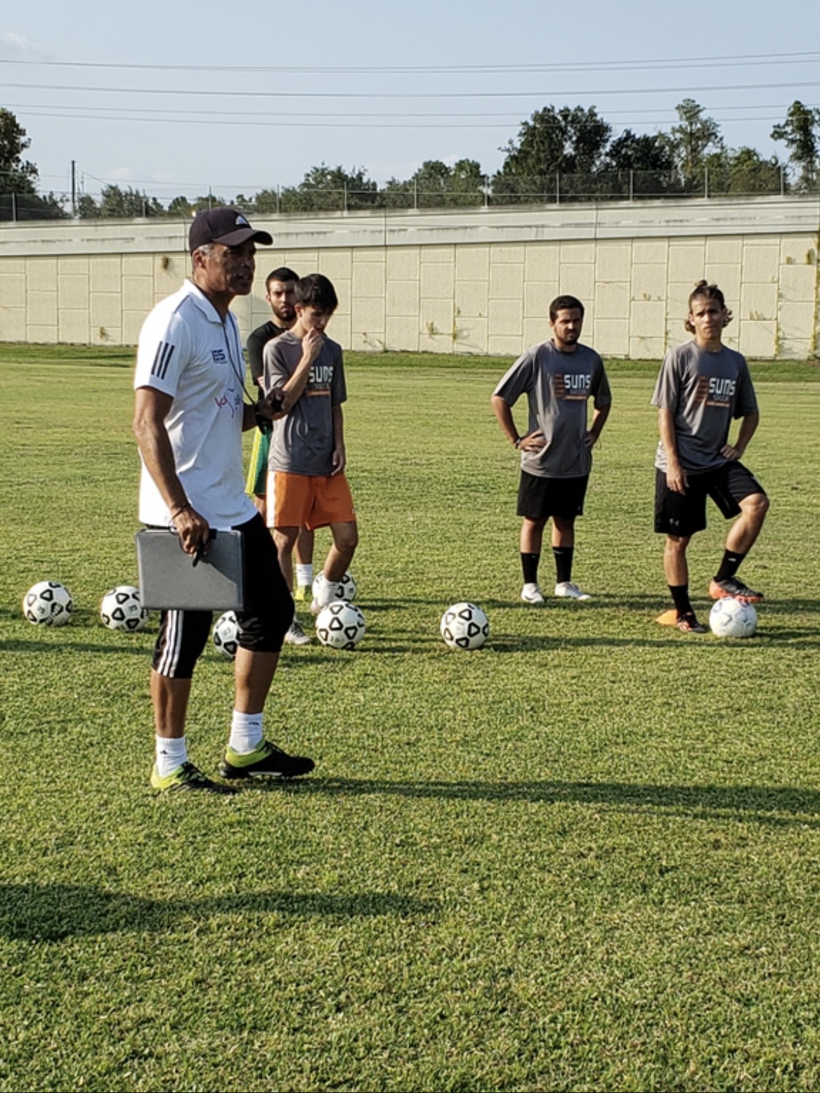 Marcelo Gonçalves giving instructions during an outdoor training session